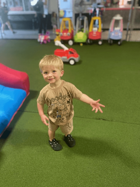 A toddler playing with toy cars
