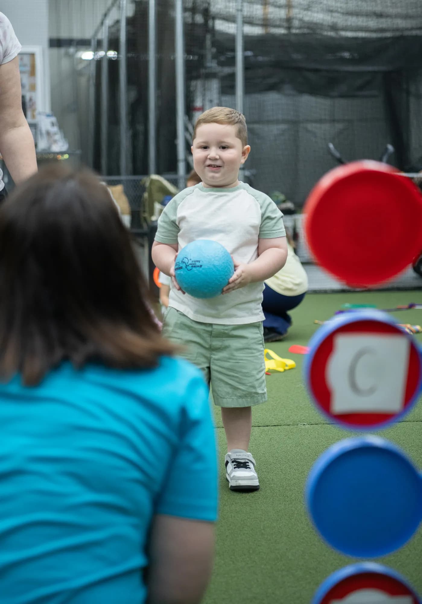 A young boy holding a ball during a CHAMP Academy movement class