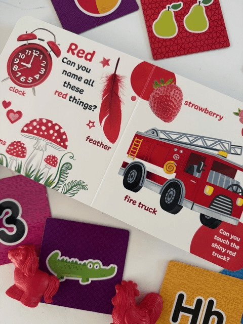 A child exploring a red color book